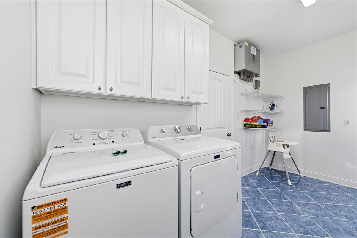 Convenient first-floor laundry room with full-size washer, dryer, and extra storage space