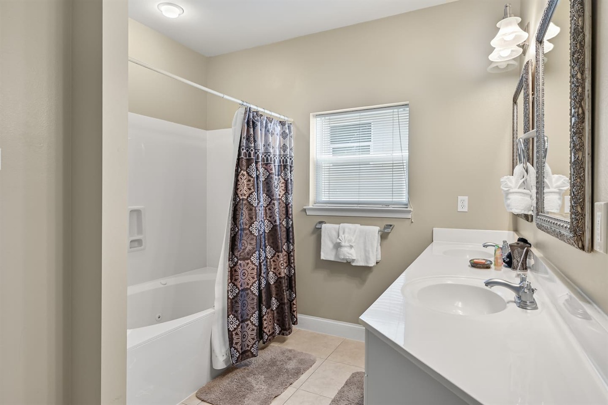 BEDROOM #2 + BATHROOM #2: King Bed with night stands, dresser, and TV. This bedroom has a private ba