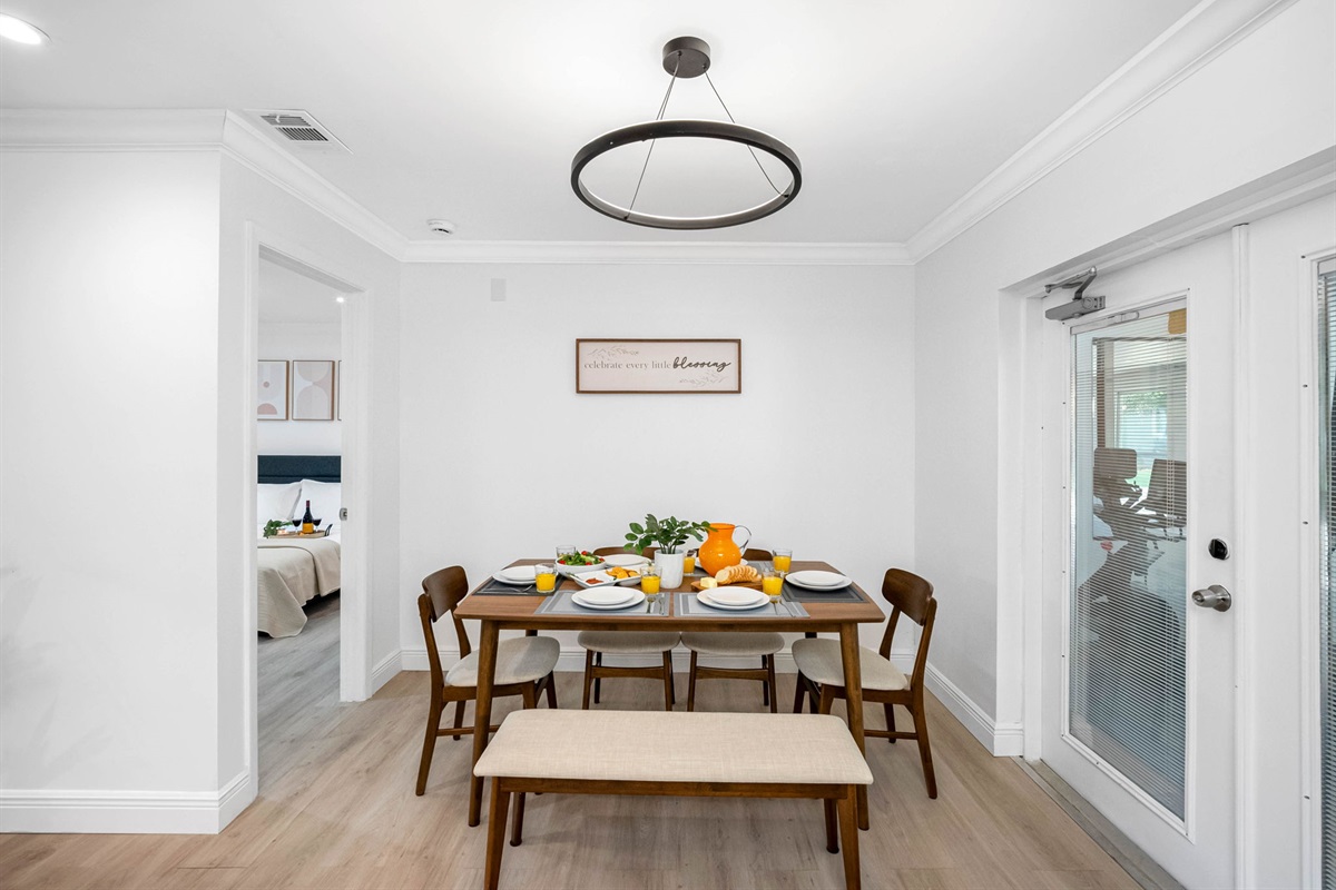 Modern wood tones, clean lines, and a pop of color from the centerpiece make this dining area effortlessly chic.