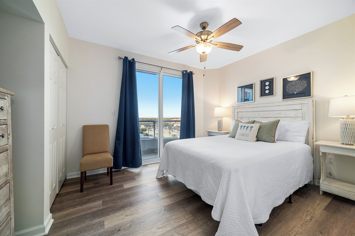 Bedroom 2 with king bed, ceiling fan and direct balcony access