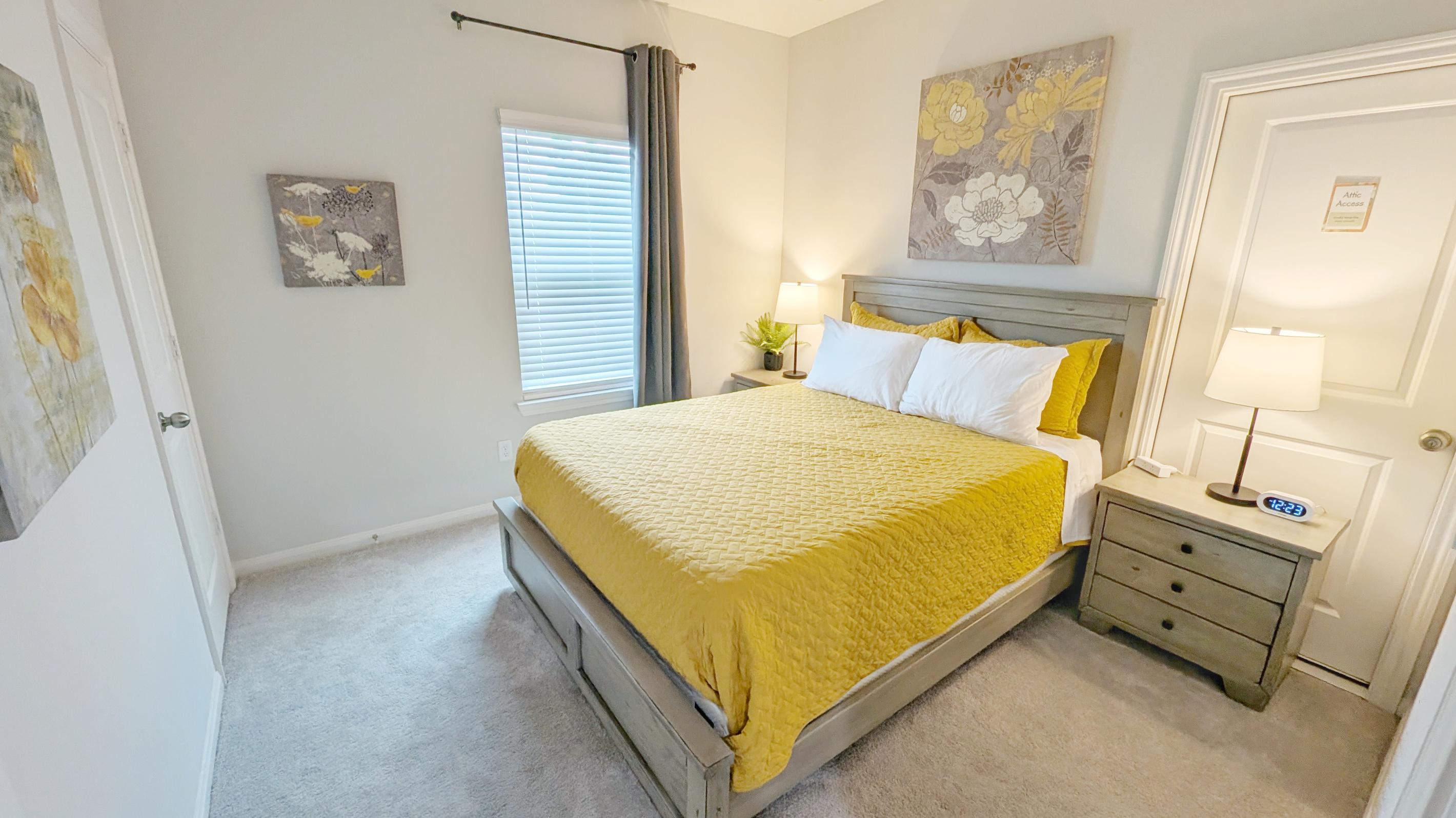 Relax in this cozy Queen bedroom with blackout curtains and a ceiling fan.