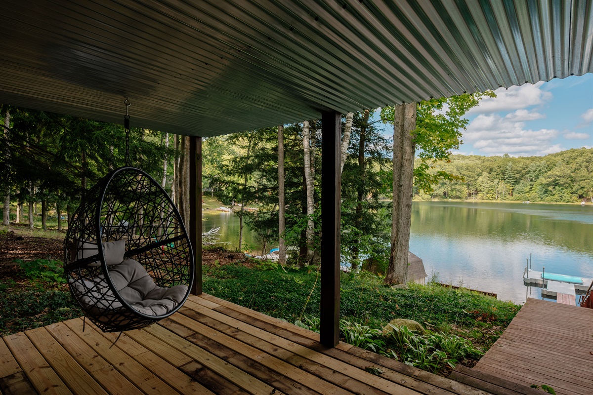 Patio with hanging chairs and peaceful lake views