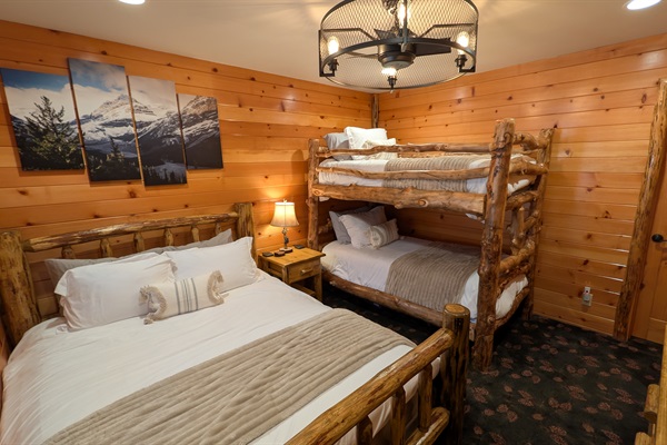Our guest room can comfortably sleep 4, with beautiful log beds, one queen and two twins. It connects directly with the hall bathroom and has a large double dresser, and LG 4K LED HDTV