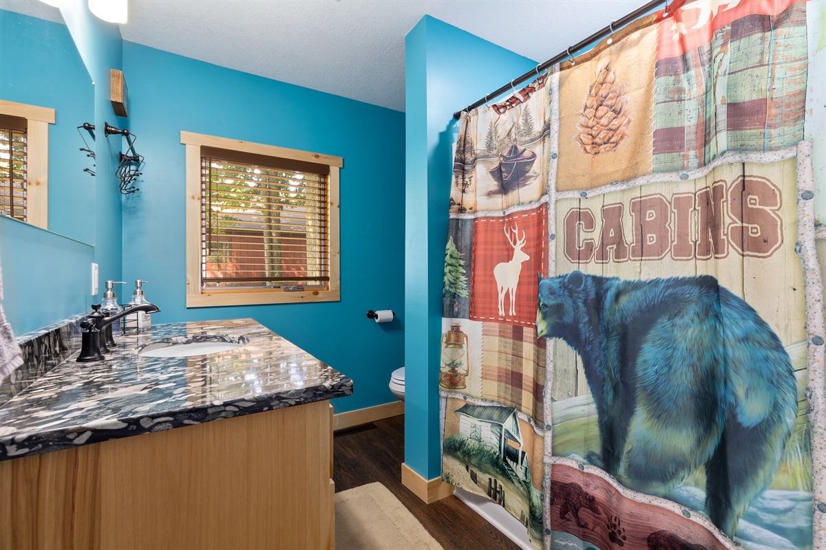 Bathroom on the main level near the kitchen has a tub/shower combination.