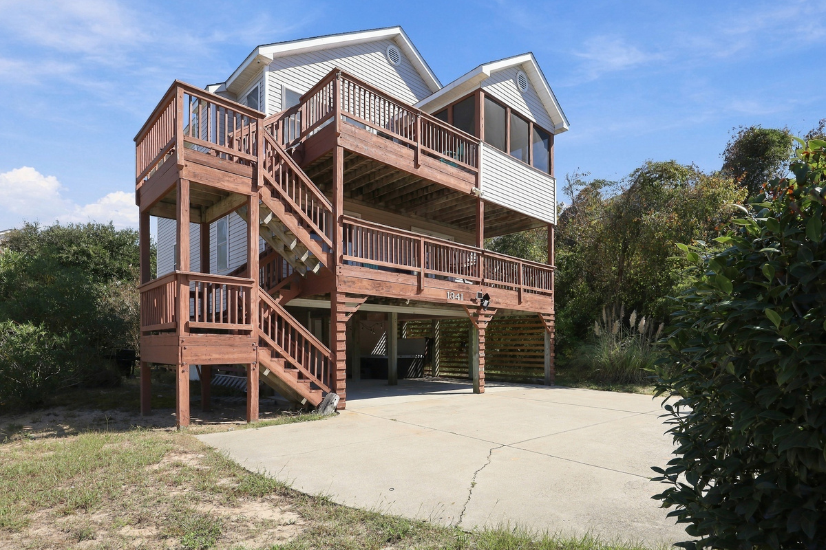 Classic Outer Banks beach house style, with stairs leading up to stacked decks.