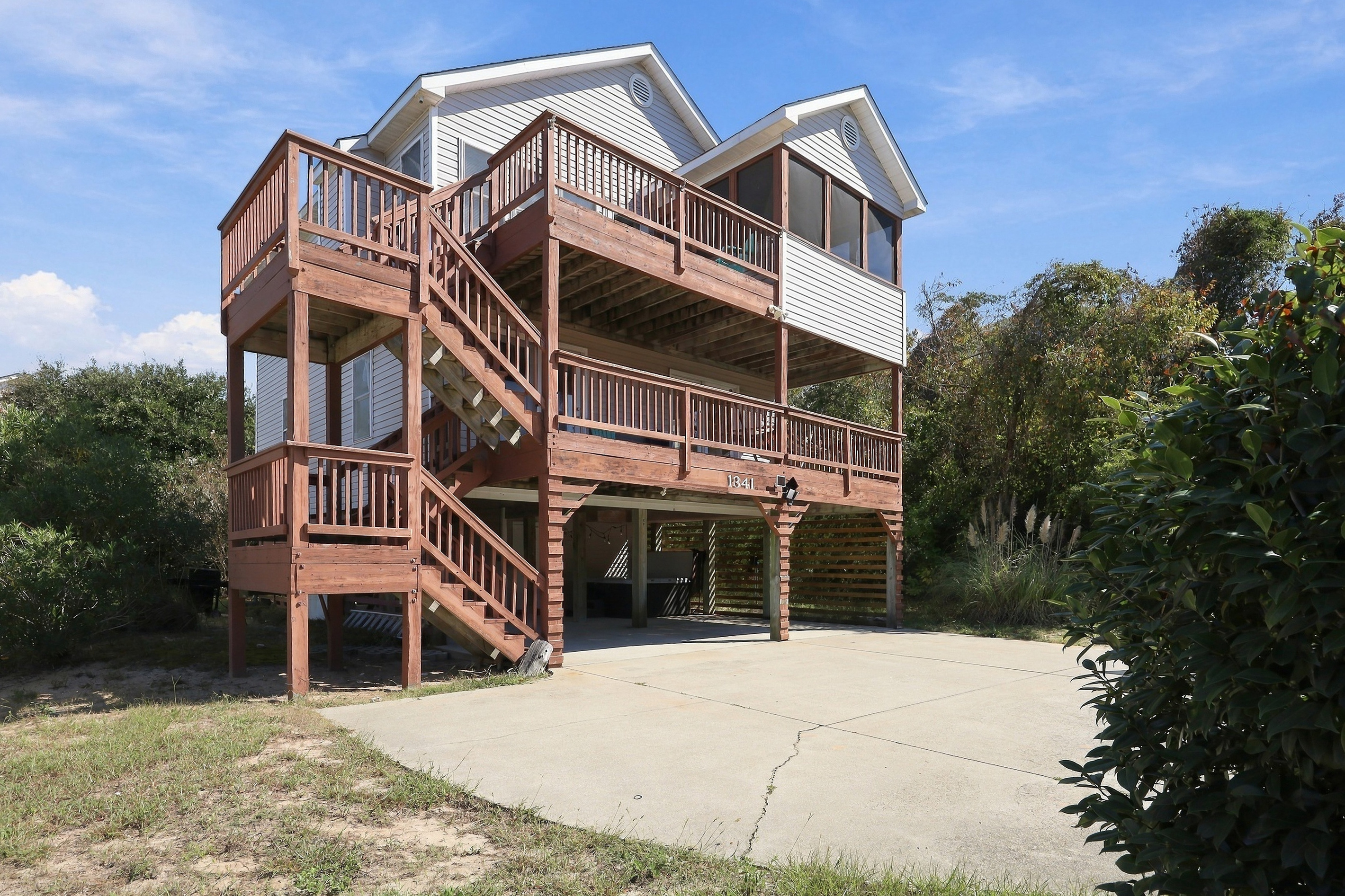 Classic Outer Banks beach house style, with stairs leading up to stacked decks.