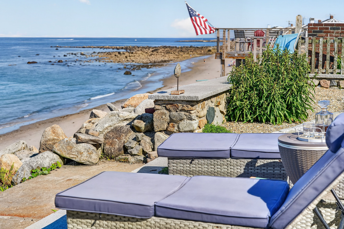 Private oceanfront patio with comfortable lounge seating just steps from the shoreline