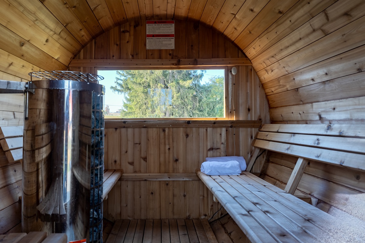 Warm up and unwind in the cozy cedar sauna, your personal spa experience in the countryside