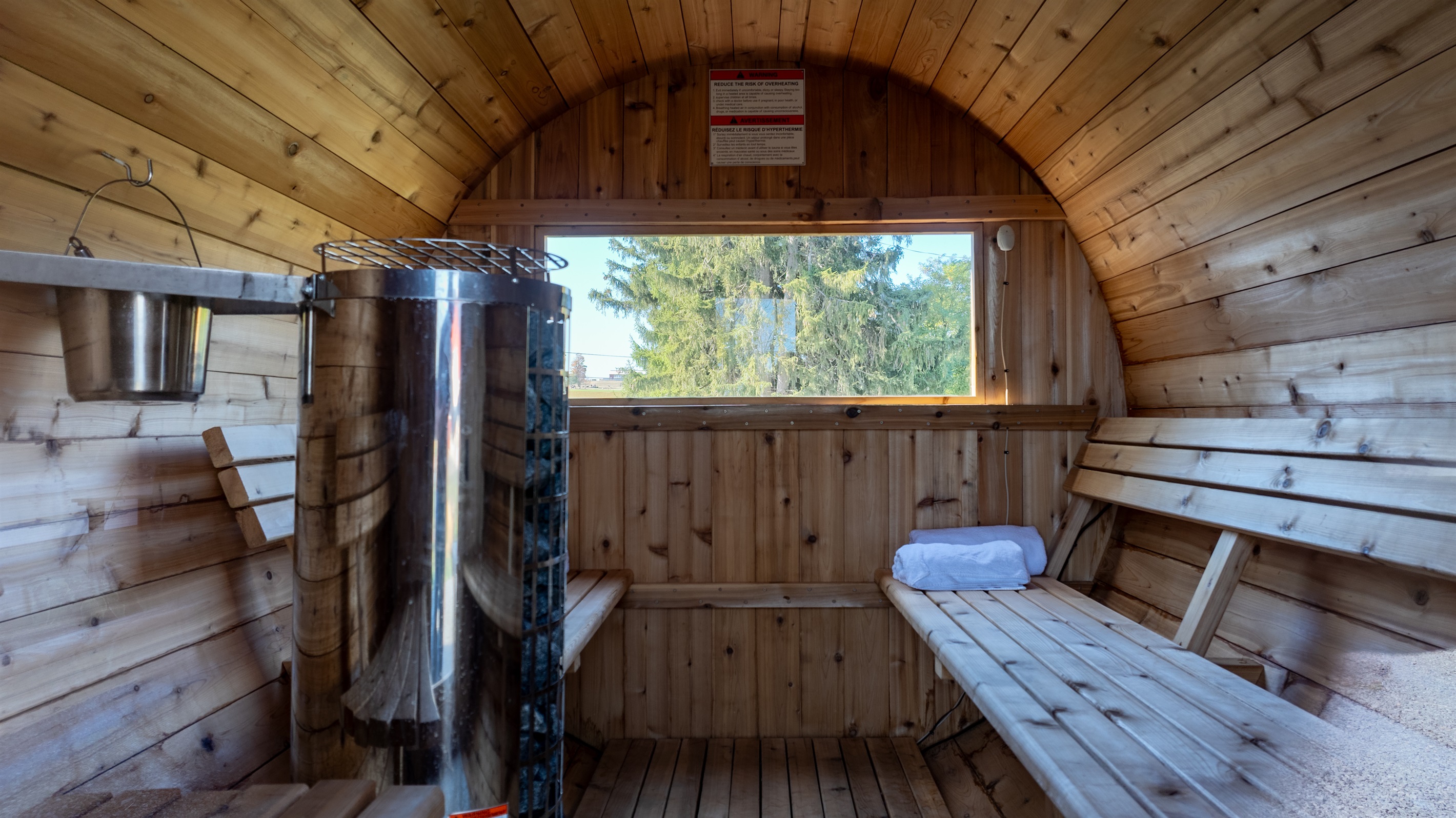 Warm up and unwind in the cozy cedar sauna, your personal spa experience in the countryside