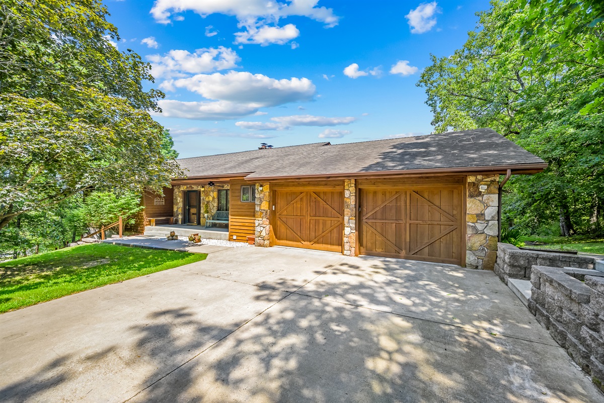 Two car garage and parking space for lots of vehicles. There are 2 additional parking pads as well as a very long driveway.