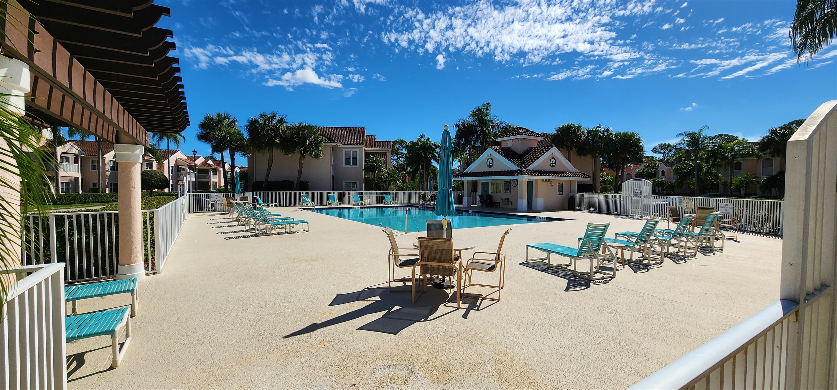 Community pool area with lounge seating, shaded spaces, and plenty of room to enjoy the Florida sunshine.