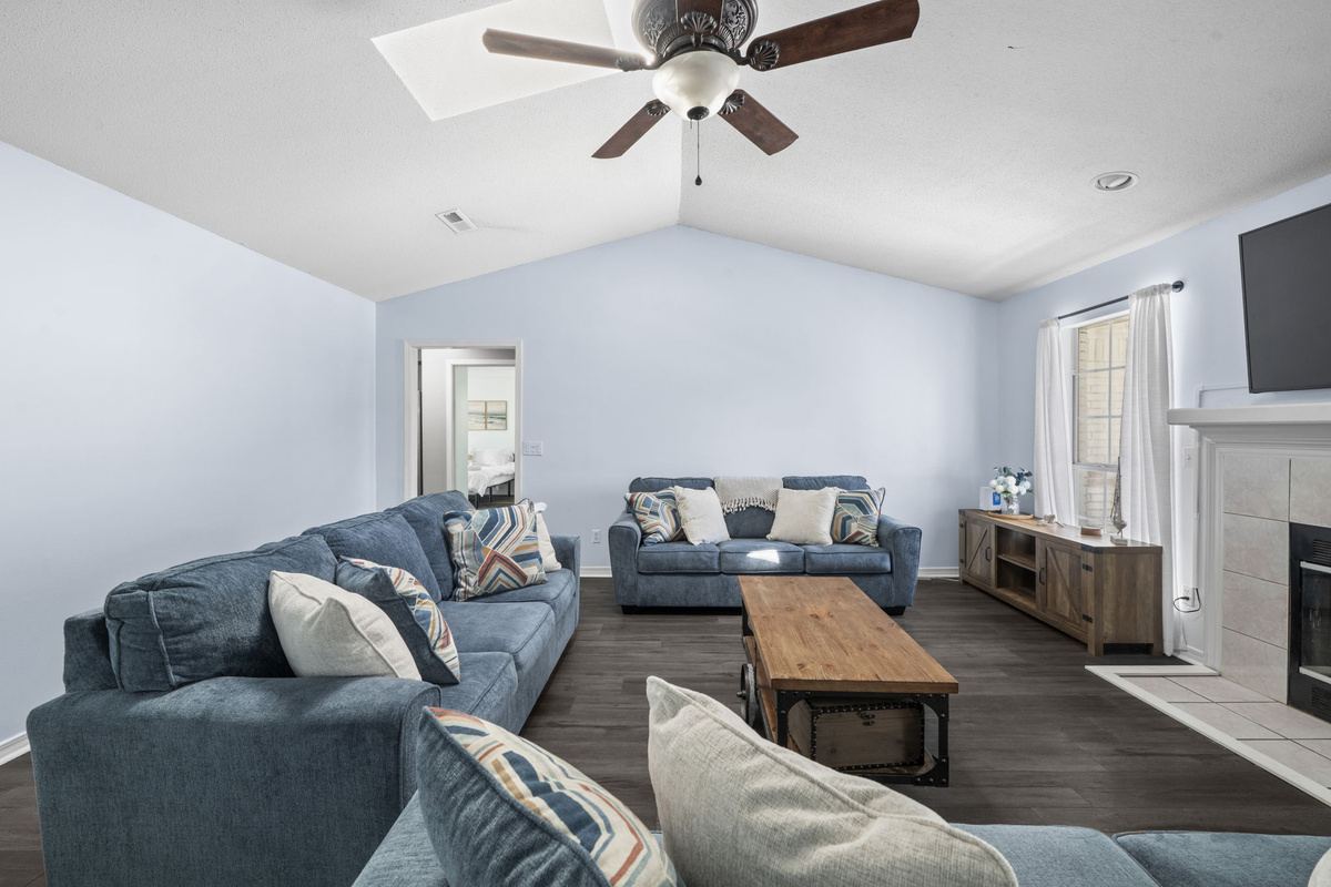 Vaulted ceilings and a skylight fill this living area with natural light, with plenty of room to relax after a day at the beach.