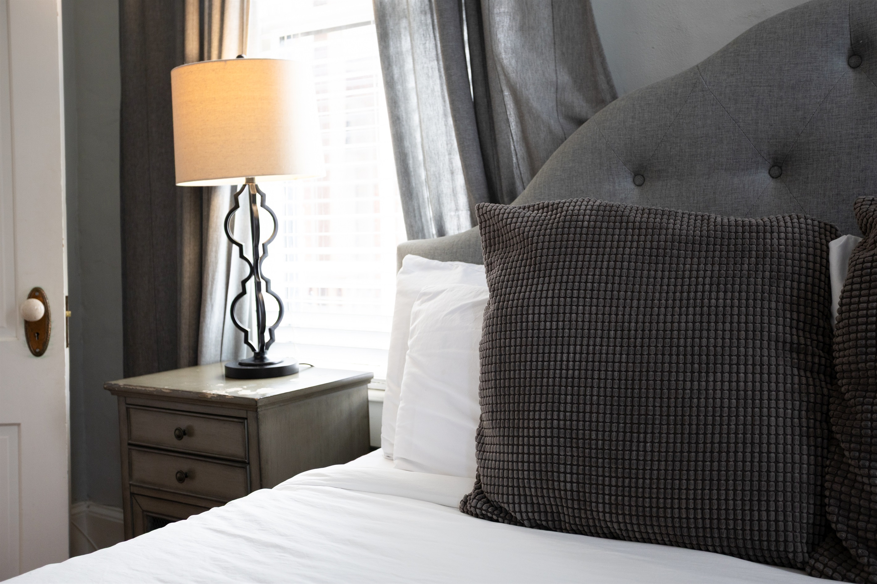 Soft lighting from the elegant lamp sets a cozy, relaxing mood.