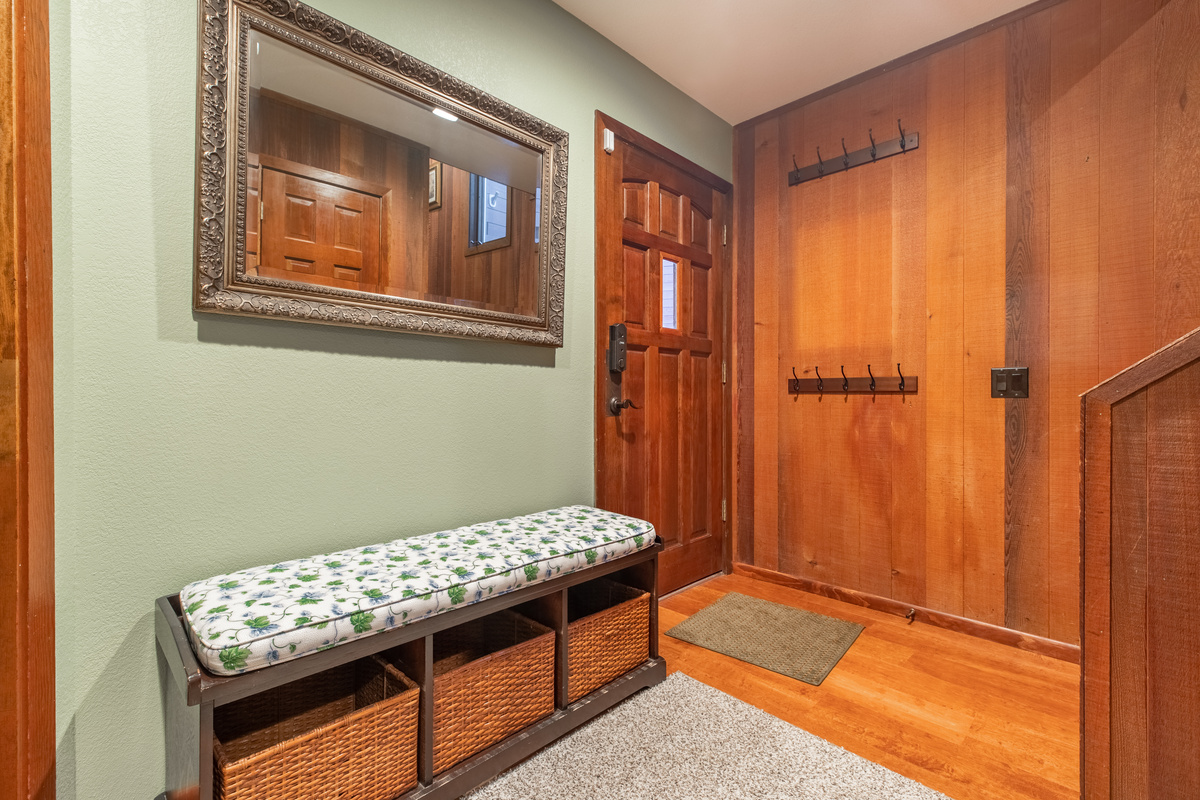 Welcoming entry hall with bench and storage for shoes.