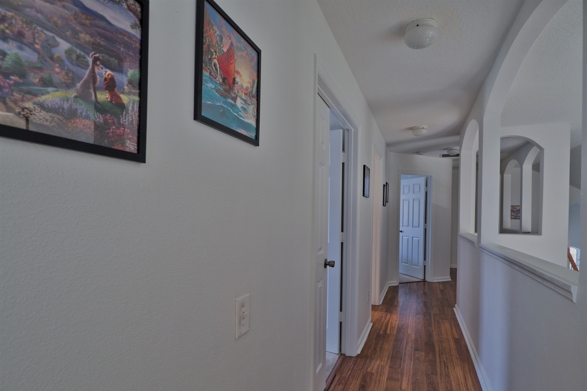 Hallway with Disney art.