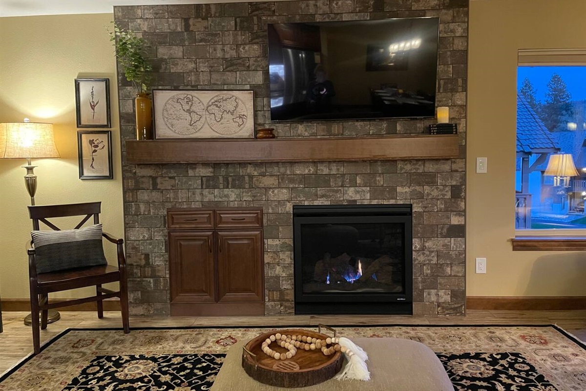 Living room with a gas fireplace and a 55” TV