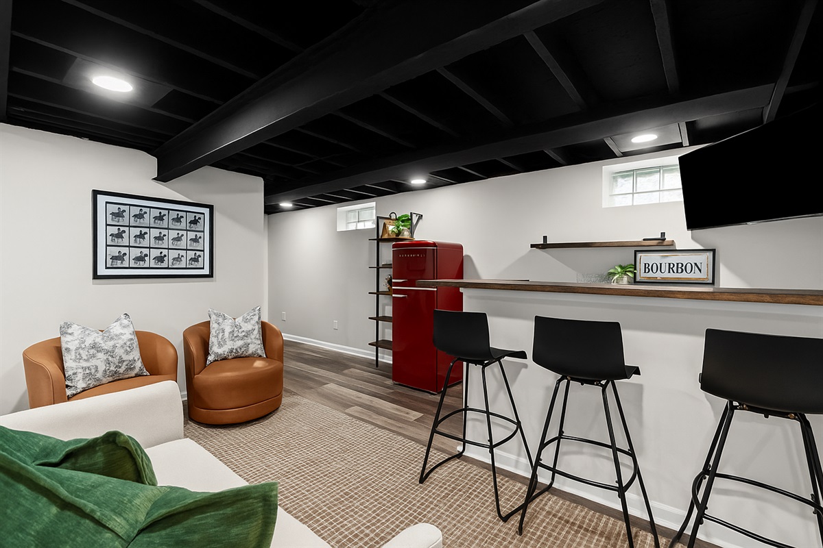 Chic basement lounge with bar seating, Smart TV, and a fun, relaxed vibe—ideal for game nights or movie marathons.