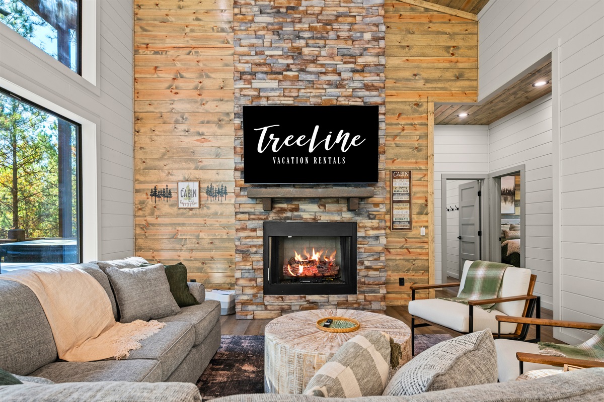 The stacked stone fireplace adds warmth and charm, creating a welcoming spot to curl up on chilly evenings.
