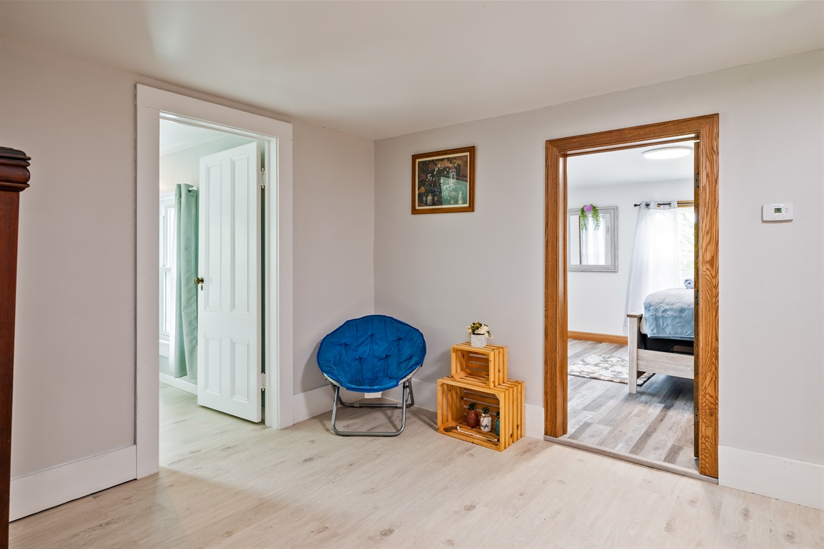 Multi-use loft area with charming accents and easy access to two private bedrooms.