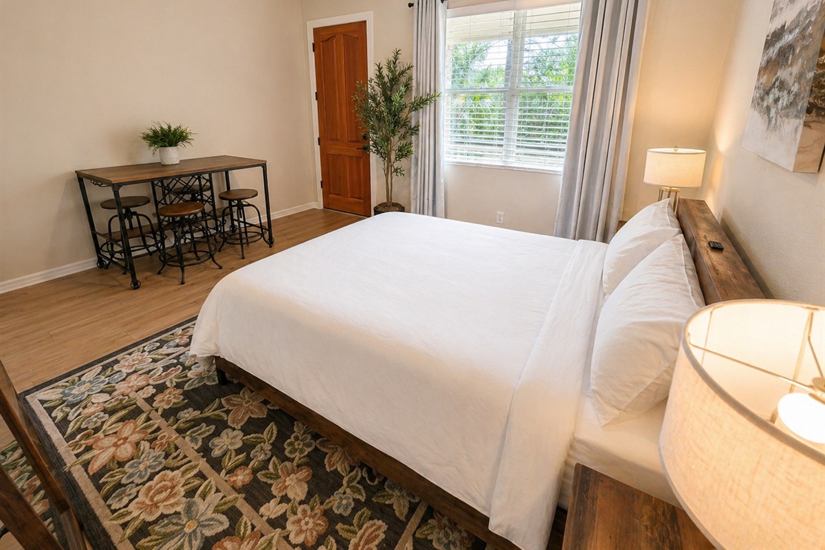 Cozy and well-appointed bedroom with a comfortable bed, soft lighting, and stylish décor. Enjoy natural light from the window and a calm, relaxing atmosphere perfect for a restful night’s sleep.