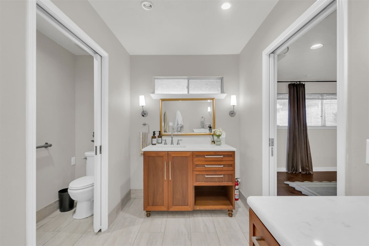 Primary bathroom with a private toilet room for added privacy and oversized, ADA-grade doorways designed for ease of access and comfort.