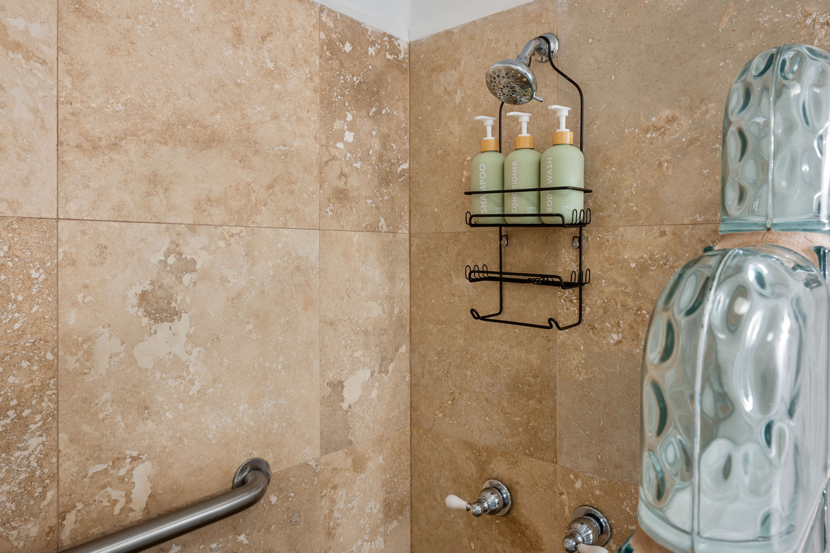 Refresh and recharge in the spacious walk-in shower after a day at the beach.