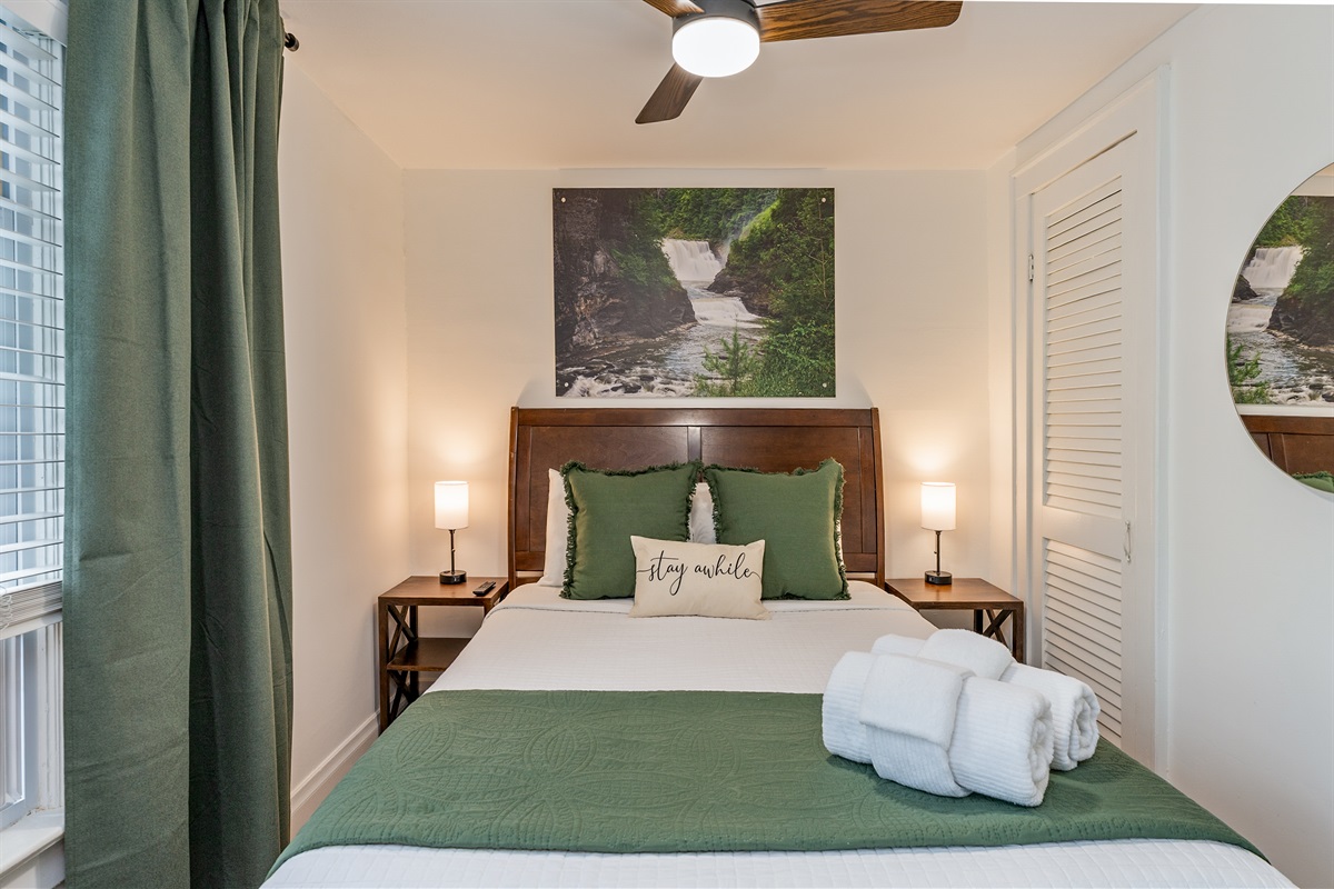 Tranquil queen bedroom retreat with nature-inspired decor, plush bedding, and soothing green accents—unwind and stay awhile! Bedroom #3