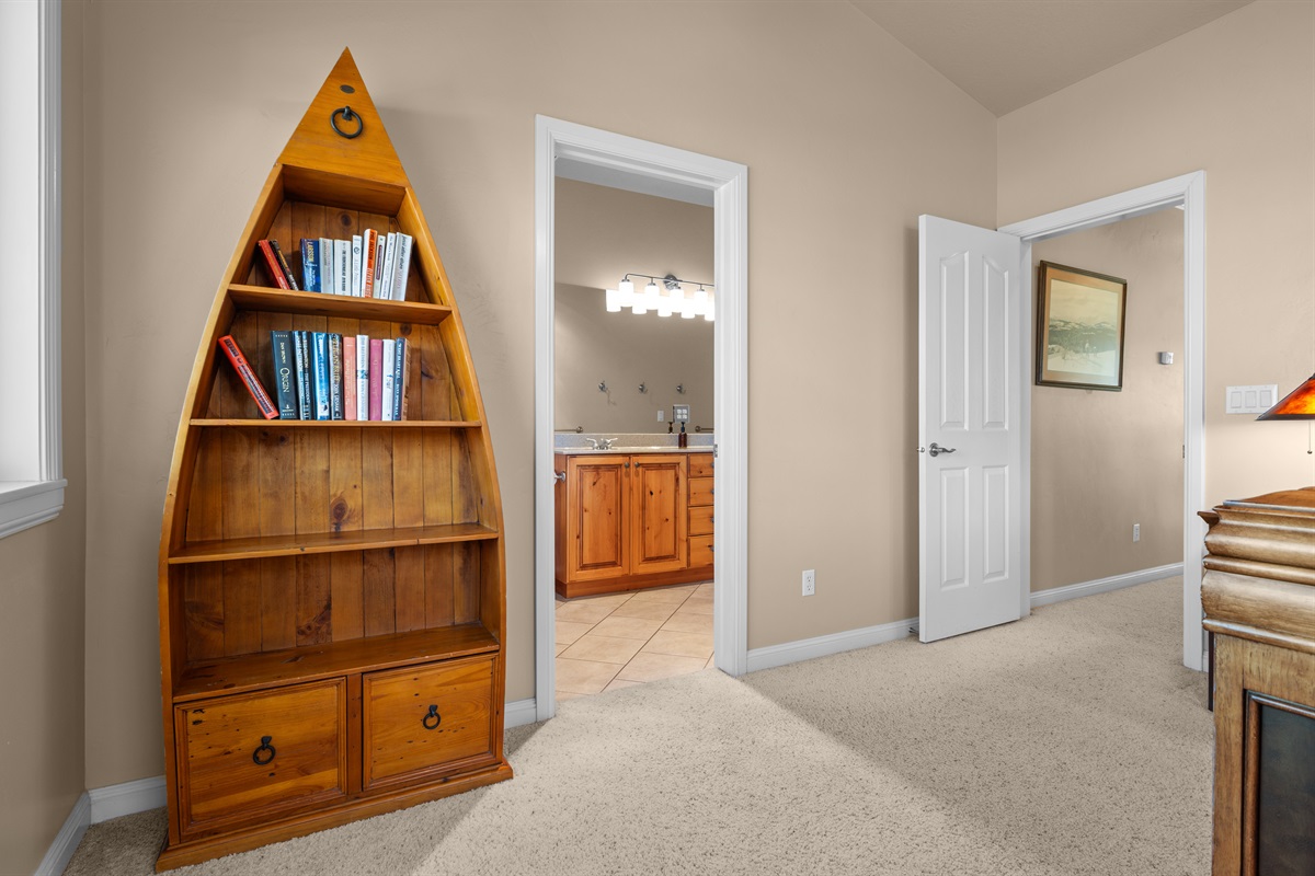 Charming bedroom details with convenient access to the ensuite bath and loft area.