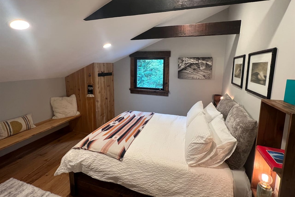 Queen bed guest room 2 with custom built in bench and vintage desk