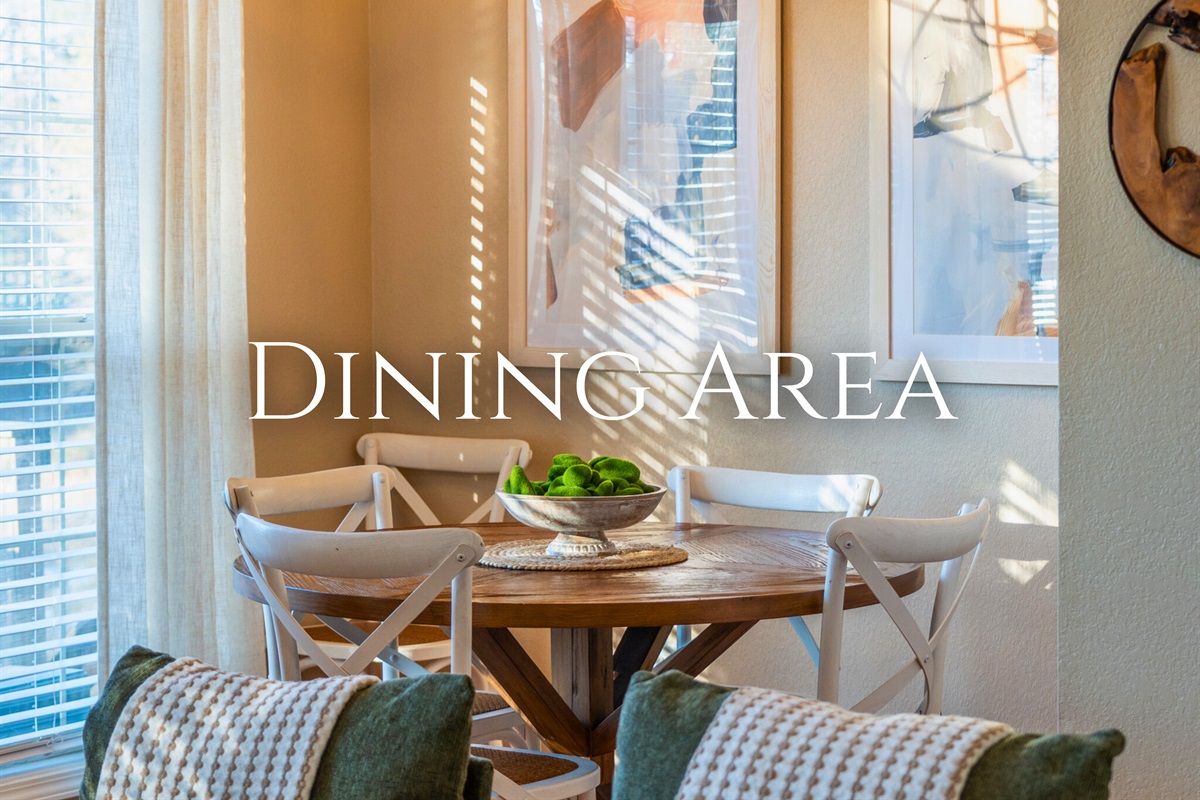 The dining area offers a cheerful place to gather, made even better by the soft natural light streaming through the windows.