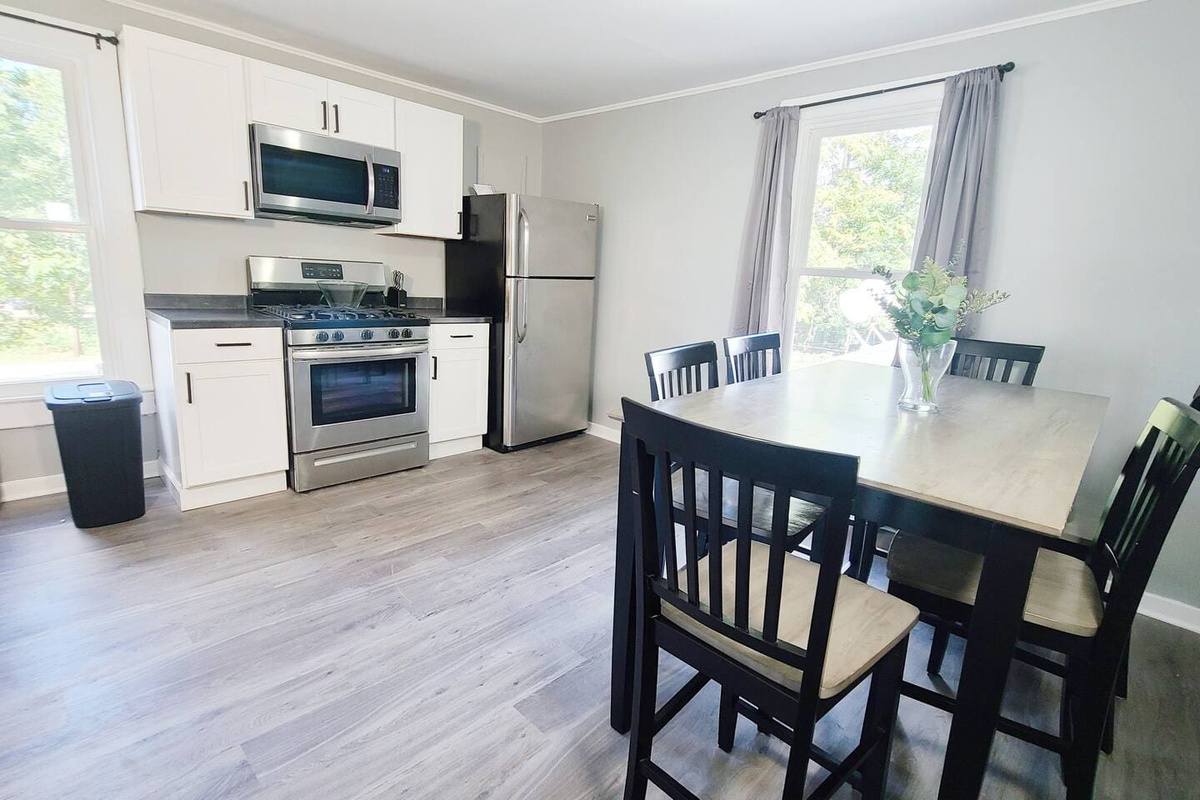 Stylish 6-seater dining area facing the kitchen, creating an open and inviting space perfect for meals and entertaining.