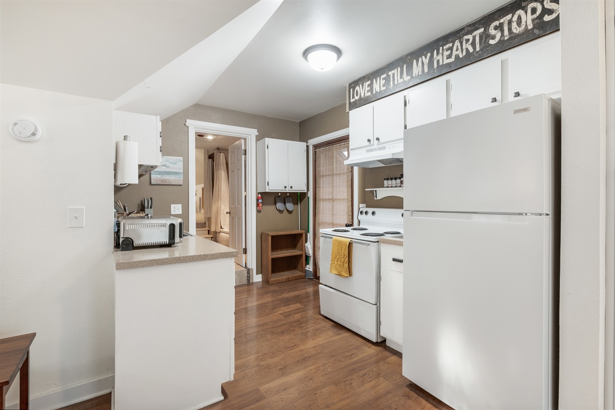 Kitchen with full oven, stove, and refrigerator
