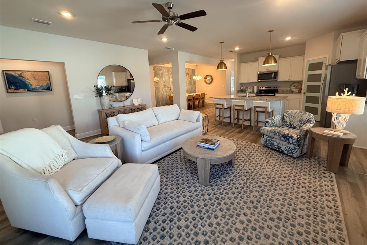 Bright, open-concept space connecting living, dining, and kitchen for seamless group gatherings.