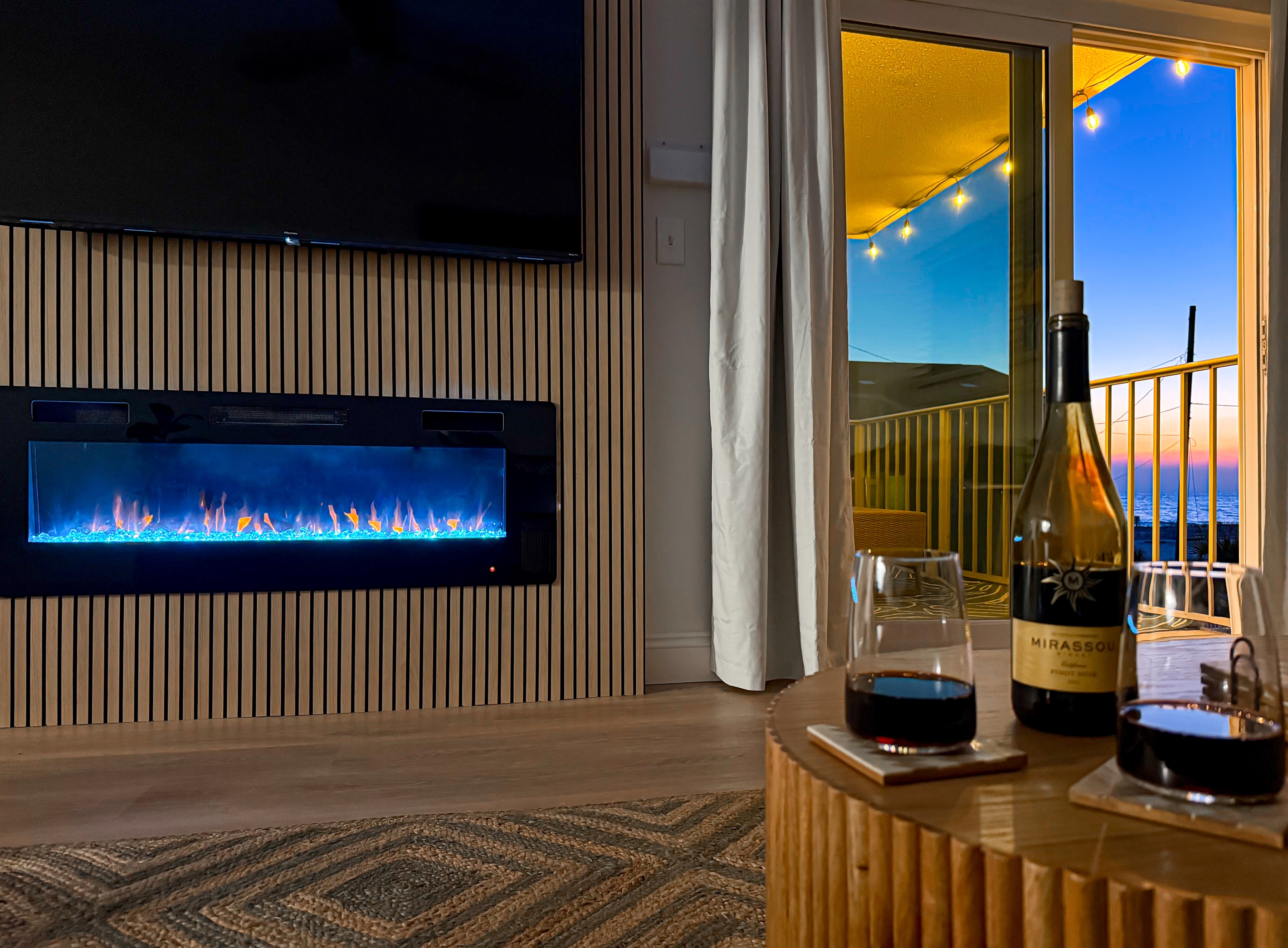 Pour a glass of wine and relax at the handmade wood coffee table. The large sliding doors open wide to let the salt air into the room.