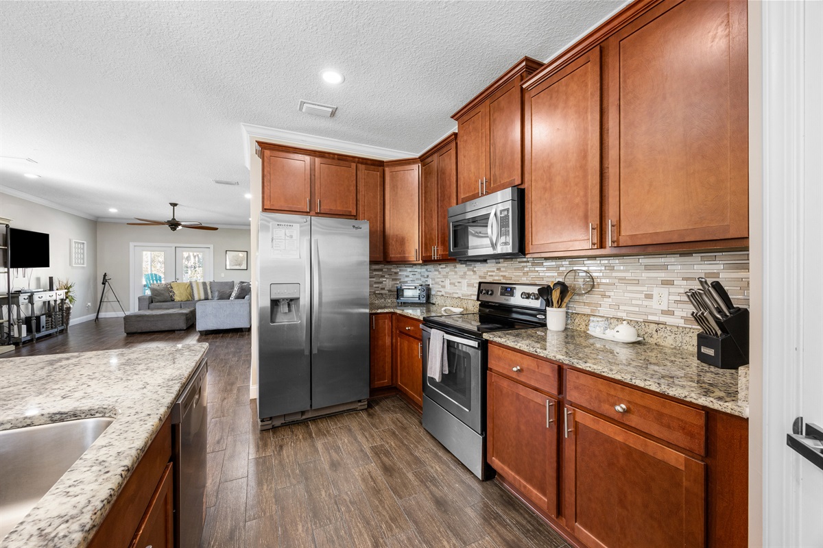 Fully equipped kitchen with stainless appliances and breakfast bar