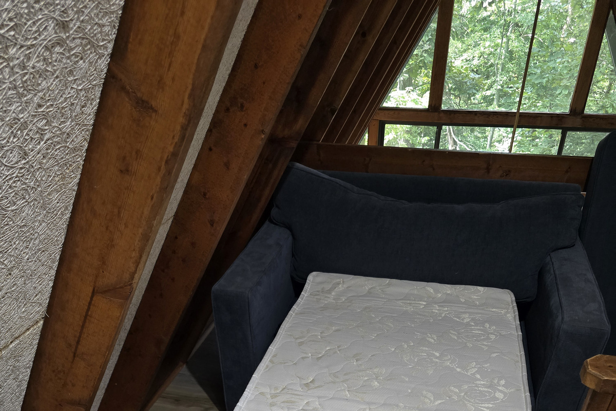 The loft couch extends out to a twin bed for an added sleeping option and linens are in the wicker trunk close by.