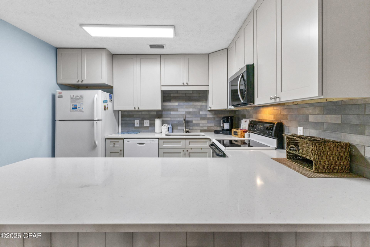 Enjoy home-cooked meals with an open kitchen and dining space, making it easy to gather together after a fun day at the beach.