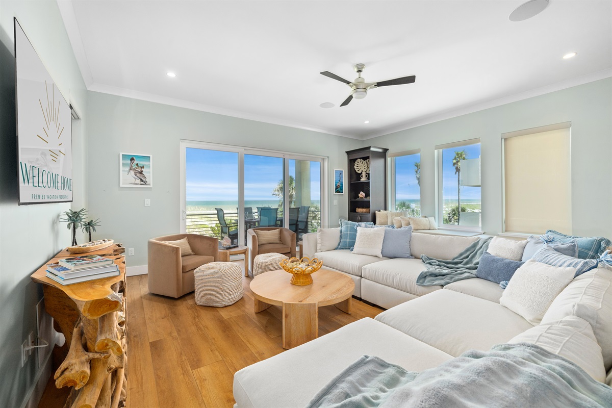 Expansive family room with plenty of seating and a panoramic view of the water