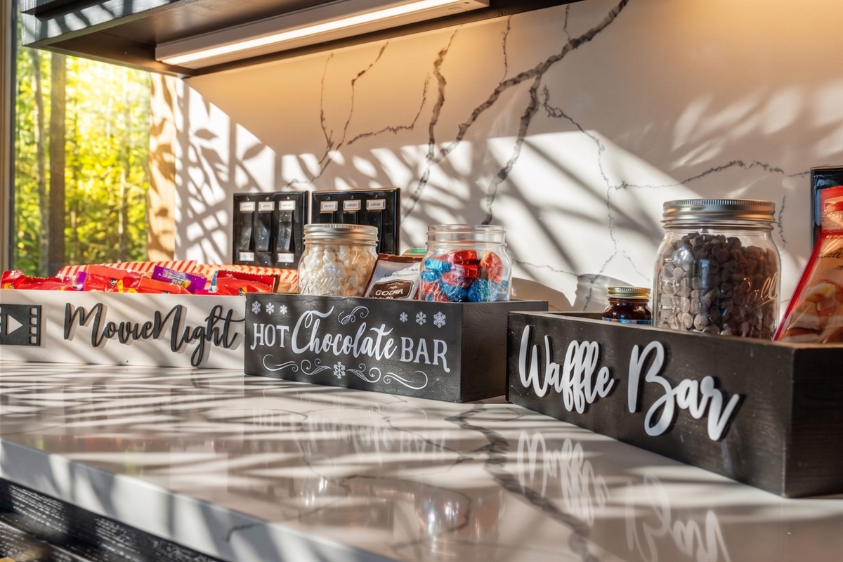 Everything you need for the ultimate cozy stay: Movie Night box full of popcorn + candy, Hot Chocolate Bar to warm your evenings, + Waffle Bar perfect for sweet morning indulgence. A delightful touch!
