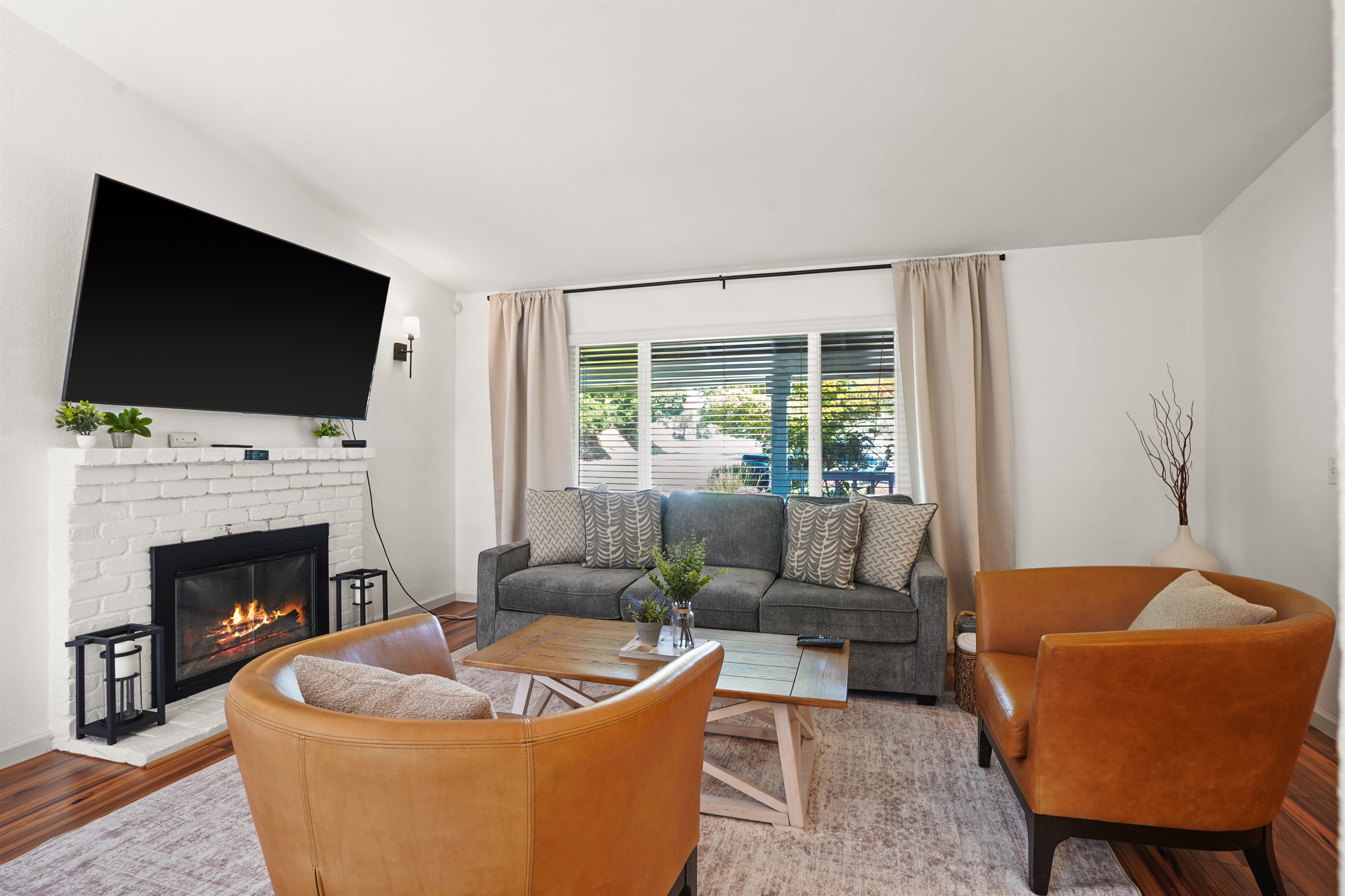 A living room that feels both elevated and effortless, with warm textures, natural light, and room to truly unwind.