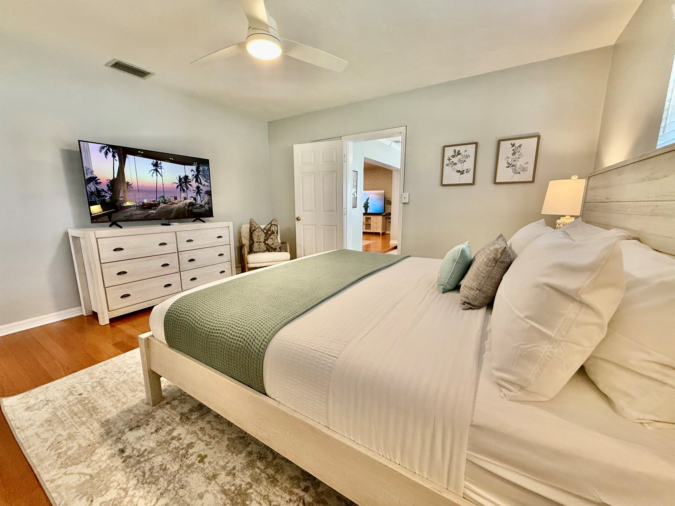 Unwind in this bright and airy master suite, complete with a king bed, Smart TV, and cozy seating nook.