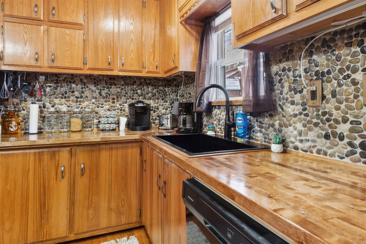 Kitchen was recently updated with a custom river rock back splash throughout for a unique look. Dishwasher available for added convenience. Dishwasher pods are available to get you started.
