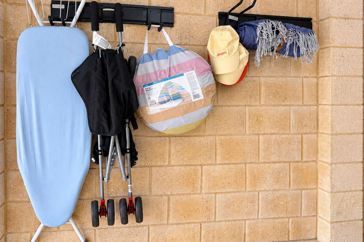 Everything you need for a day out, with a pop-up beach shelter, fold-up stroller, sun hats and a beach blanket hanging ready in the garage, plus an ironing board.