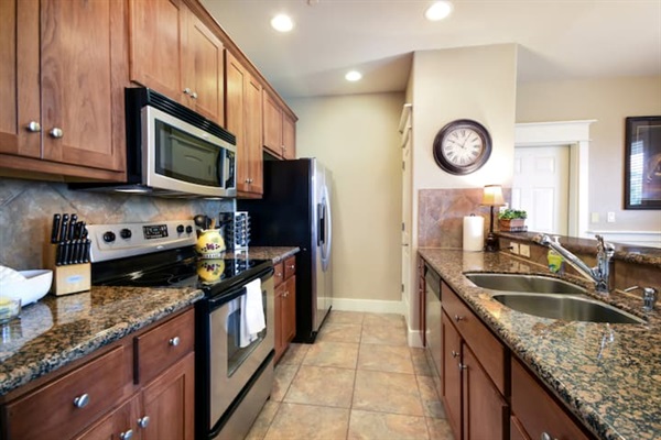 Fully equipped kitchen with granite countertops, full-size appliances, and everything needed for easy meals during your stay