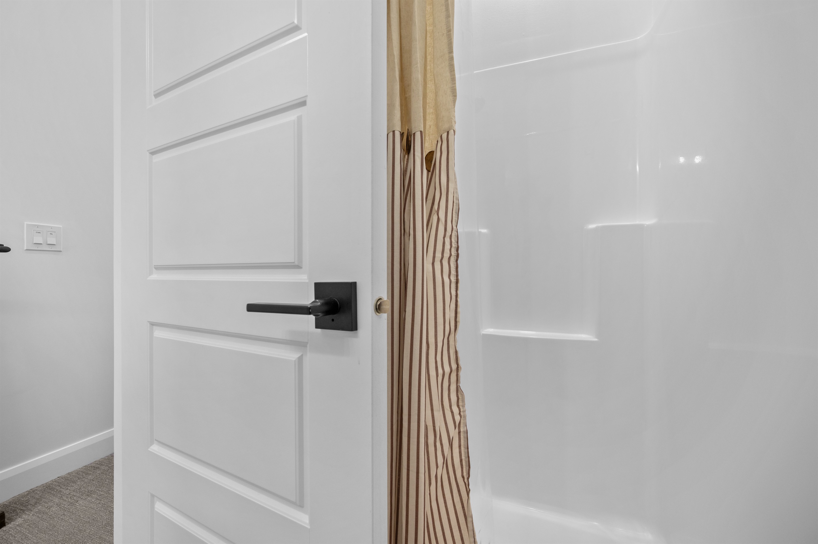 Glass-enclosed shower with neutral tile and spa-like feel.