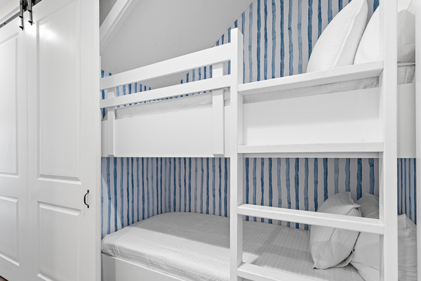 These charming built-in bunk beds provide extra sleeping space while adding a fun, cozy spot the kids will love—perfect for families and making the most of your beach getaway!
