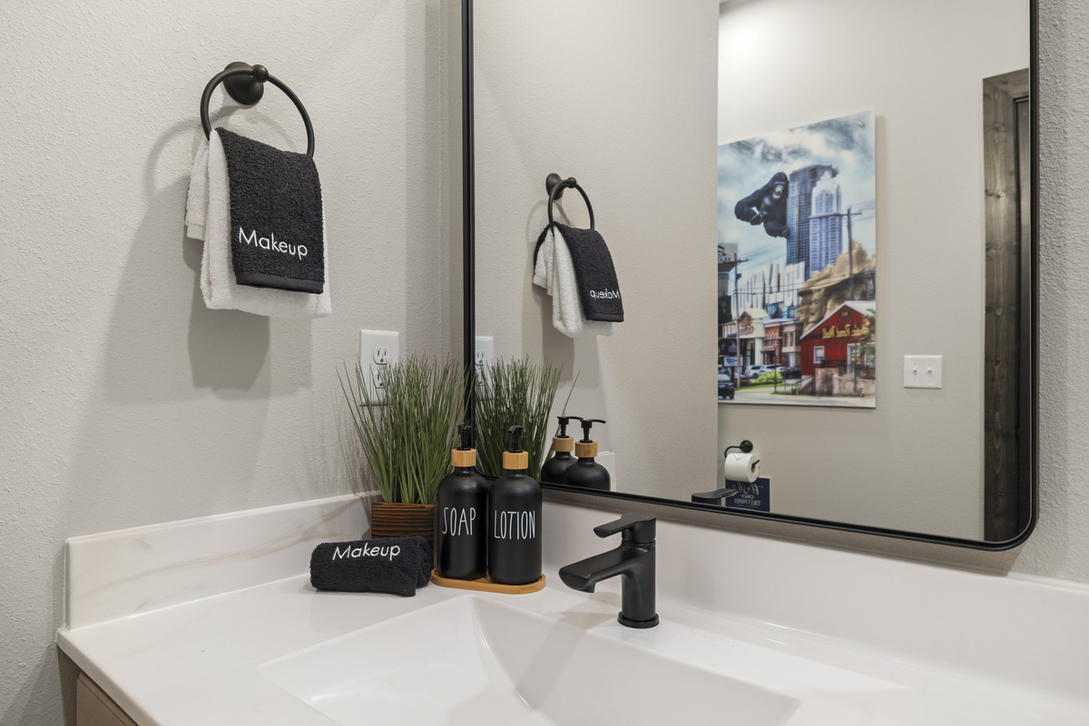 Lit mirror and a 'Makeup' towel at the ensuite vanity.