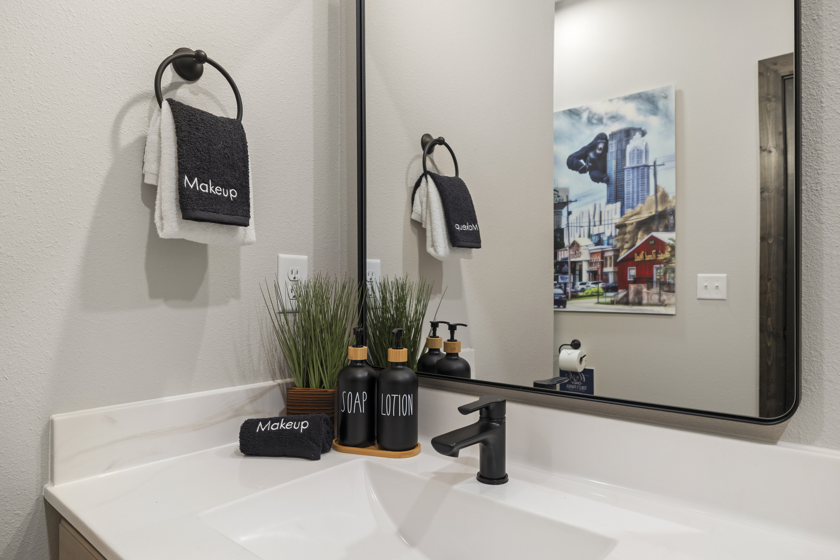 Lit mirror and a 'Makeup' towel at the ensuite vanity.