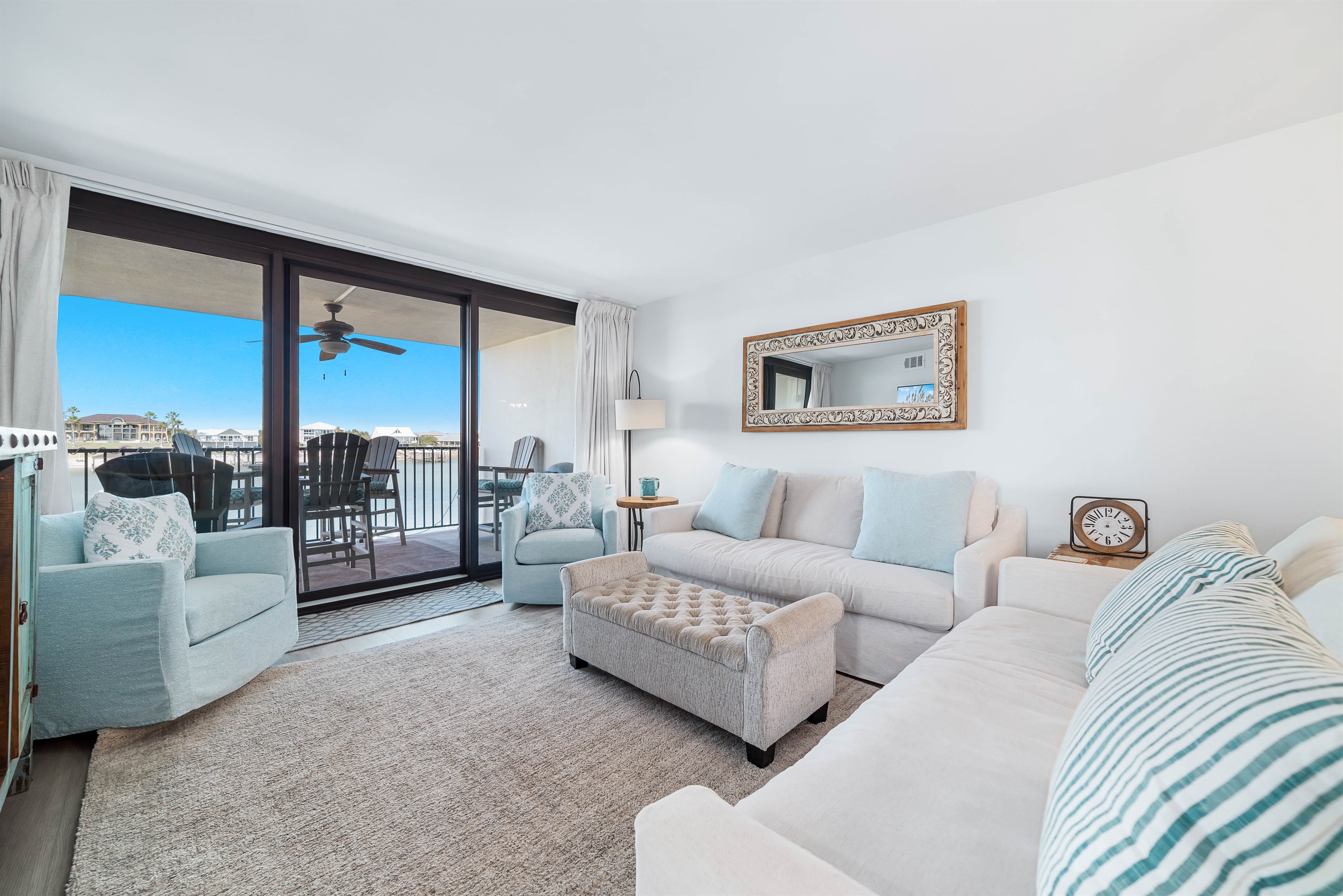 Unwind and soak in the beauty of Ole River and Ono Island from this stunning living room. The glass windows offer unparalleled views, creating a seamless connection with the surrounding landscape.