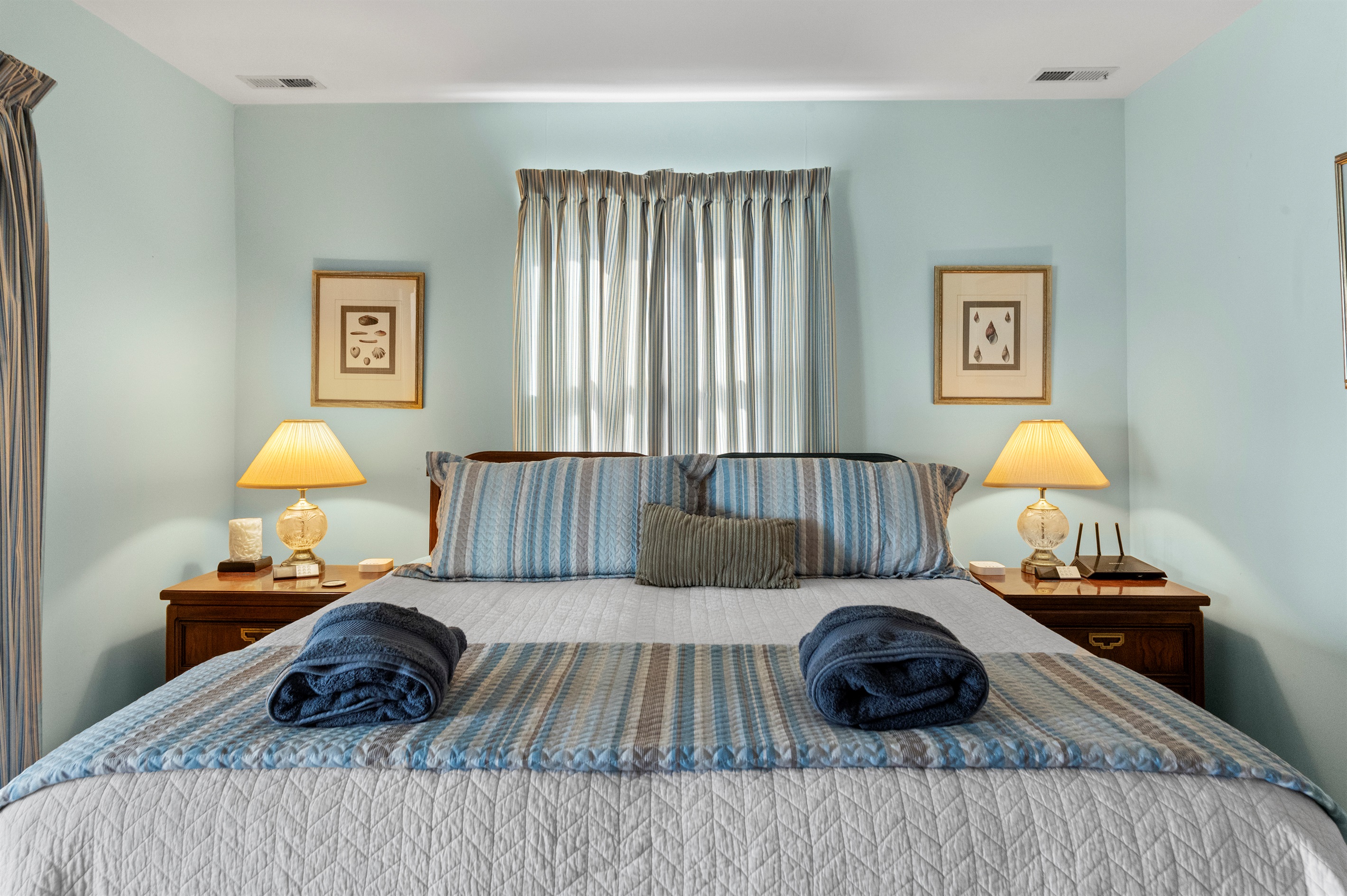 Master Bedroom King: Light-filled haven with plush bedding and serene decor for a restful getaway!